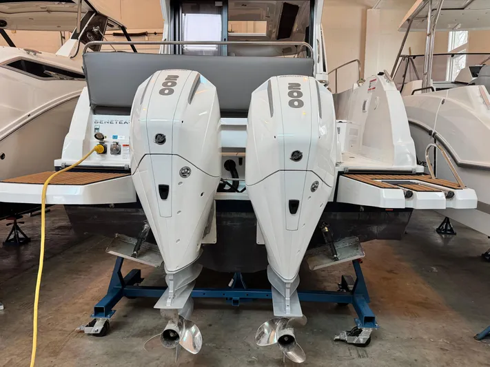  Yacht Photos Pics 2022 Beneteau Antares 9 with dual outboard engines in a showroom.