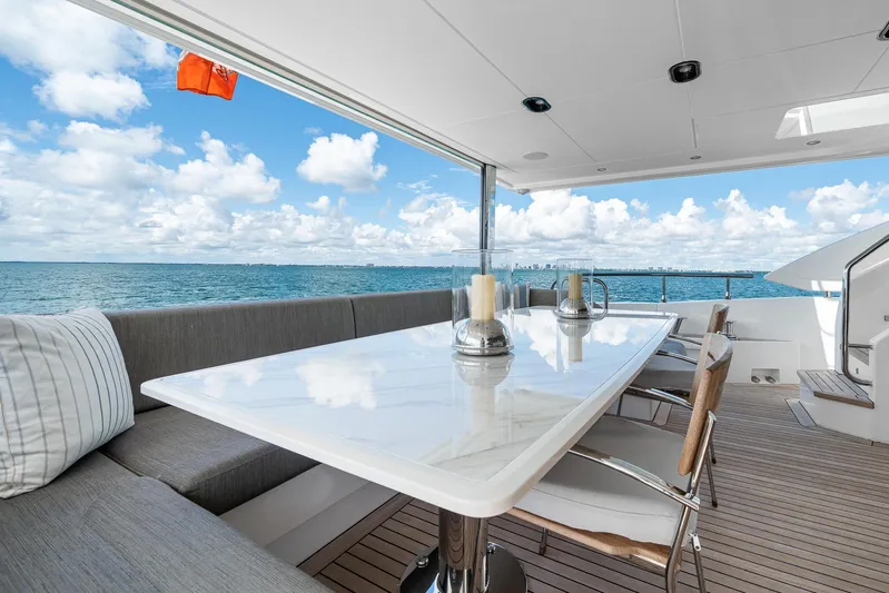 No Name Yacht Photos Pics Luxurious Azimut Grande 27 METRI yacht deck with elegant dining area, ocean view, 2022 model.