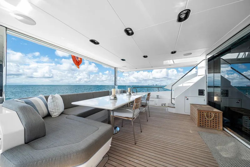 No Name Yacht Photos Pics Luxurious Azimut Grande 27 METRI yacht deck with ocean view, featuring elegant seating and dining area.