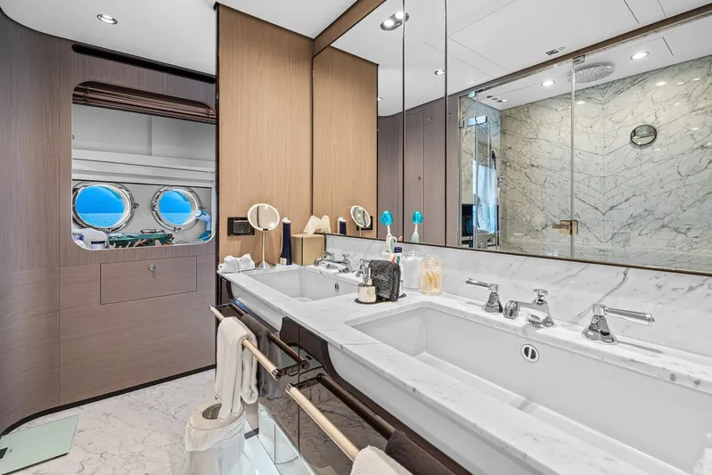 No Name Yacht Photos Pics Luxurious bathroom in 2022 Azimut Grande 27 METRI yacht with marble finishes and dual sinks.