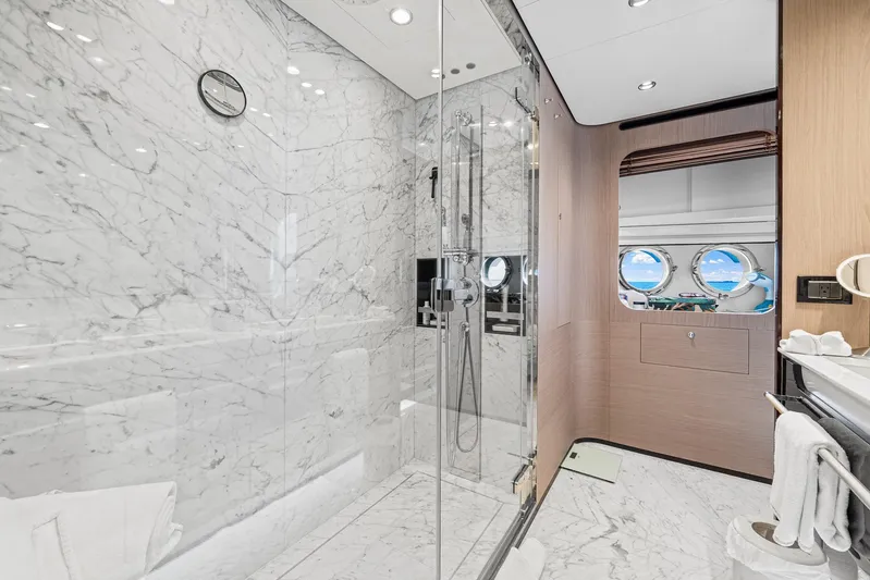 No Name Yacht Photos Pics Luxurious marble bathroom on 2022 Azimut Grande 27 METRI yacht with glass shower and porthole view.