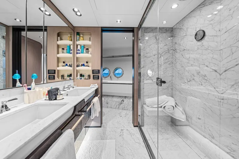 No Name Yacht Photos Pics Luxurious bathroom in 2022 Azimut Grande 27 METRI yacht with marble finishes and dual sinks.