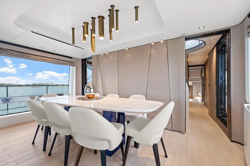 No Name Yacht Photos Pics Luxurious dining area on 2022 Azimut Grande 27 METRI yacht with elegant decor and sea view.