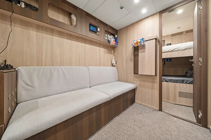 No Name Yacht Photos Pics Interior of 2022 Azimut Grande 27 METRI yacht with modern wood paneling and cozy seating.