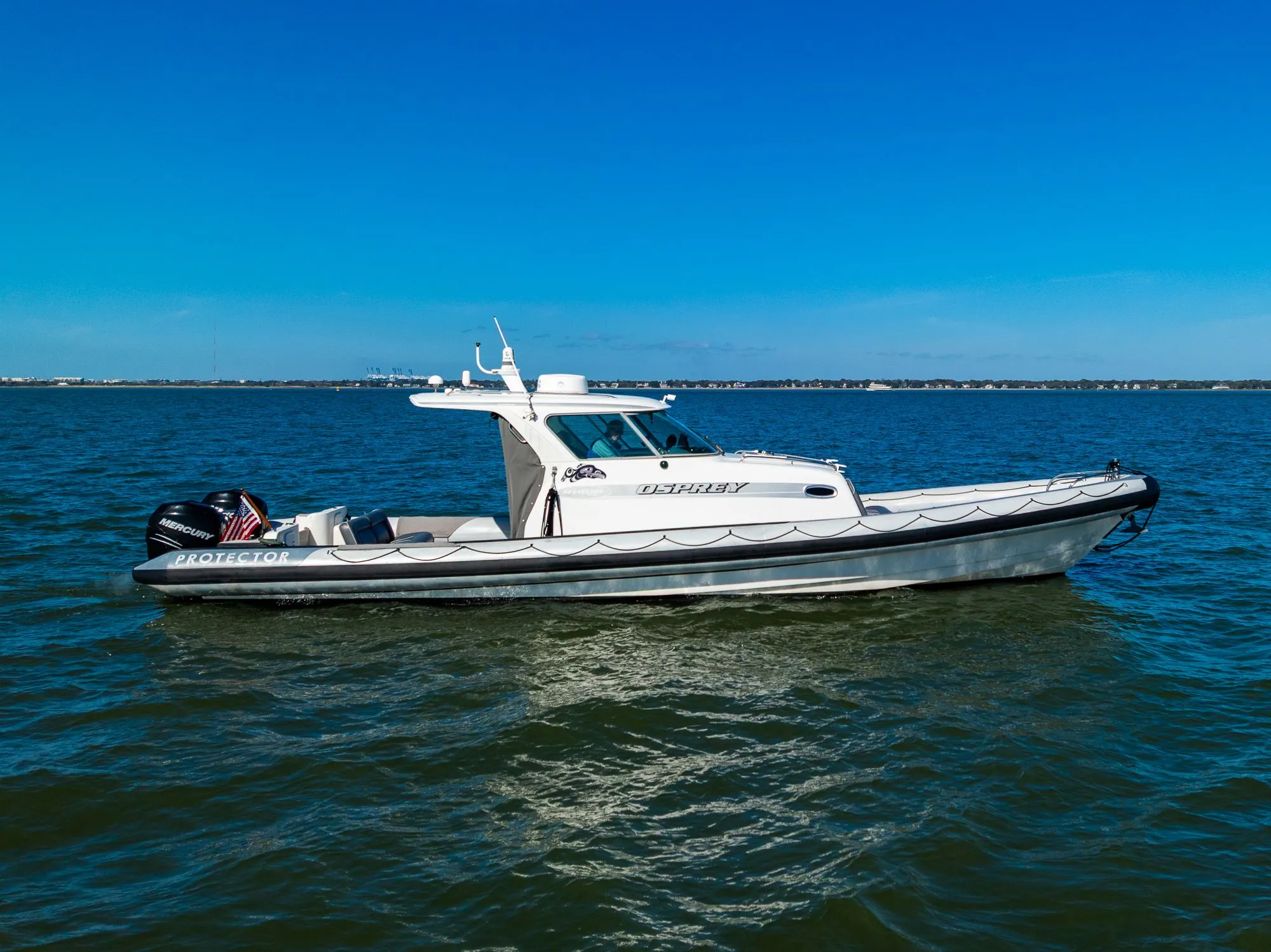 2008 Protector 410 Targa boat on calm water.