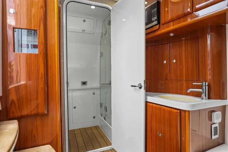 Polar II Yacht Photos Pics Luxurious 2020 HCB 53 yacht interior with wooden cabinetry and modern bathroom amenities.