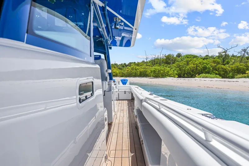 Polar II Yacht Photos Pics 2020 HCB 53 boat docked near a sandy beach with clear blue water.