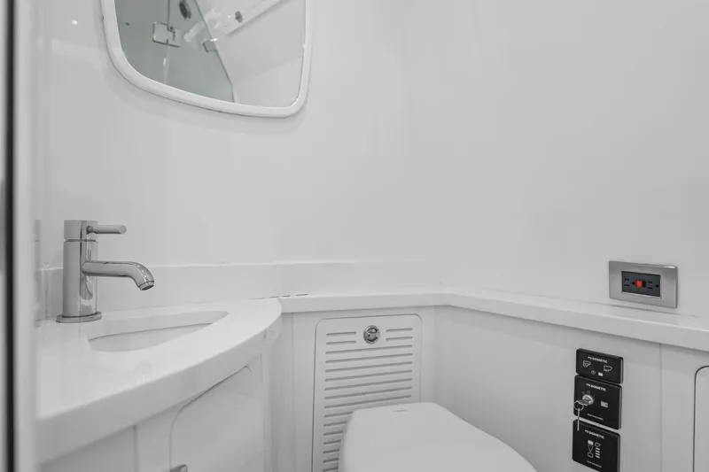 Polar II Yacht Photos Pics Modern bathroom interior on 2020 HCB 53 boat, featuring sleek sink and mirror.