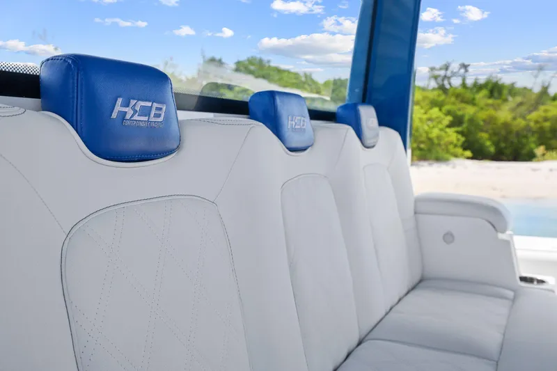 Polar II Yacht Photos Pics Luxurious seating in a 2020 HCB 53 boat, featuring blue headrests and white upholstery.