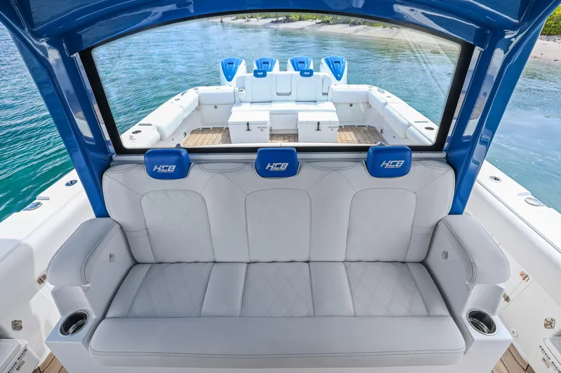 Polar II Yacht Photos Pics Luxury seating on a 2020 HCB 53 boat, featuring blue accents and ocean backdrop.