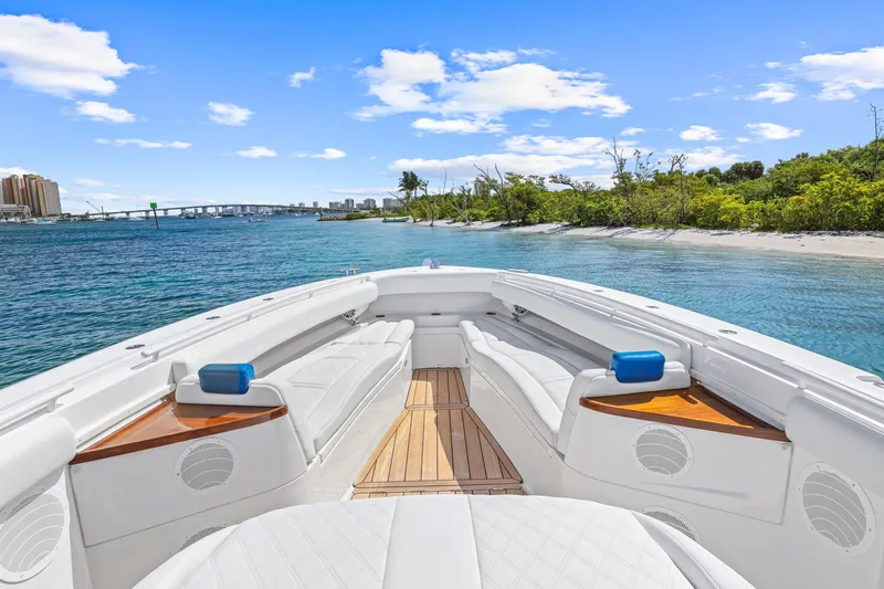 Polar II Yacht Photos Pics Luxurious 2020 HCB 53 boat interior with white seating, wooden accents, and scenic waterfront view.