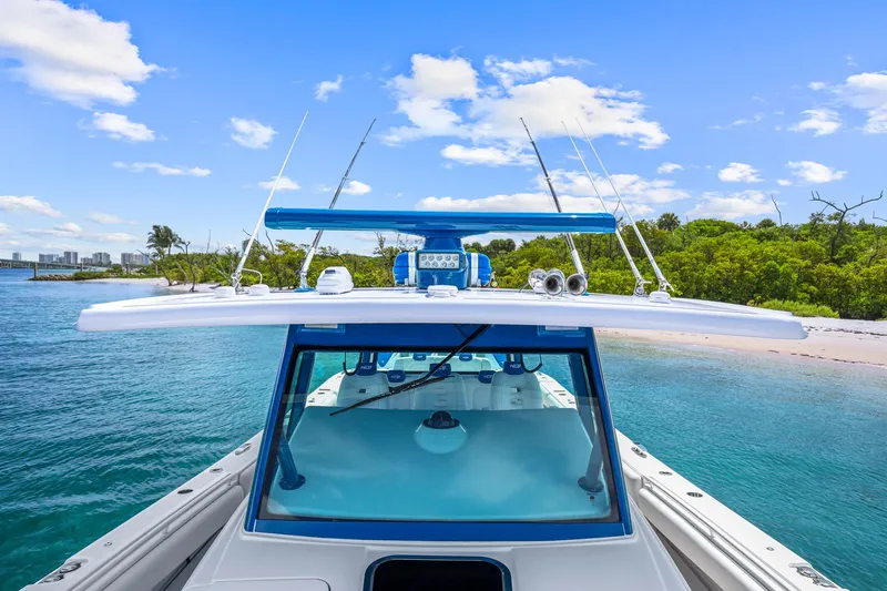 Polar II Yacht Photos Pics 2020 HCB 53 boat on clear water near a sandy beach and lush greenery.
