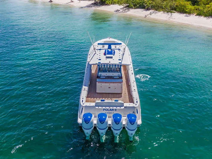 Polar II Yacht Photos Pics HCB 53 boat, 2020 model, cruising near a tropical beach with clear blue water.