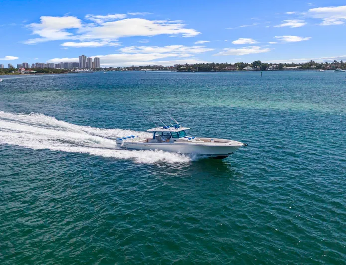 Polar II Yacht Photos Pics 2020 HCB 53 boat cruising on blue water with city skyline in background.