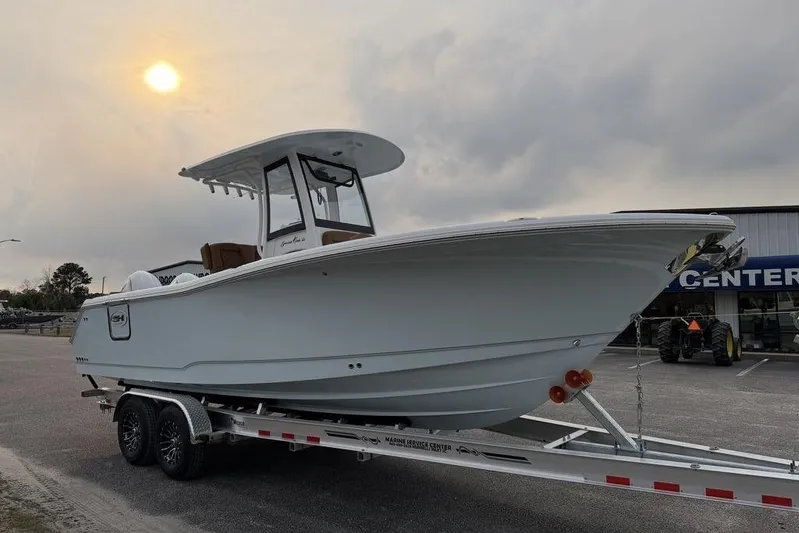  Yacht Photos Pics 2026 Sea Hunt Gamefish 25 boat on trailer under cloudy sky.