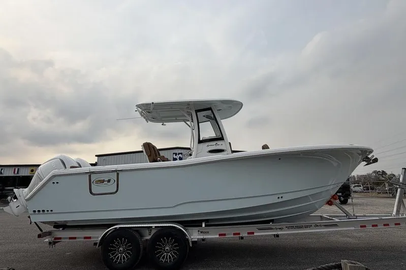  Yacht Photos Pics 2026 Sea Hunt Gamefish 25 boat on trailer under cloudy sky.