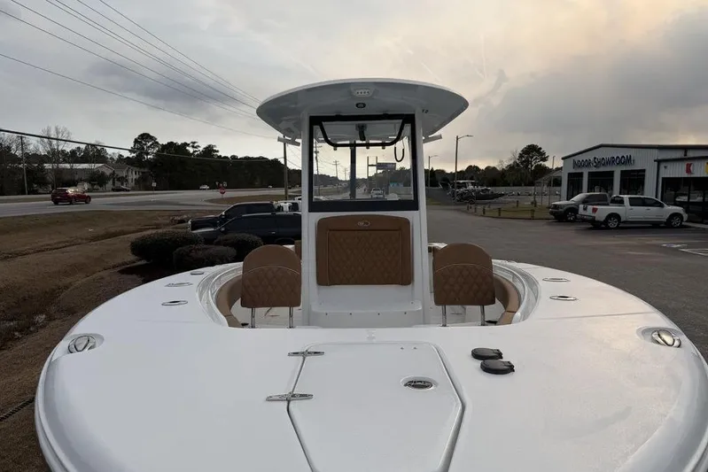  Yacht Photos Pics 2026 Sea Hunt Gamefish 25 boat with sleek design, parked near a showroom.