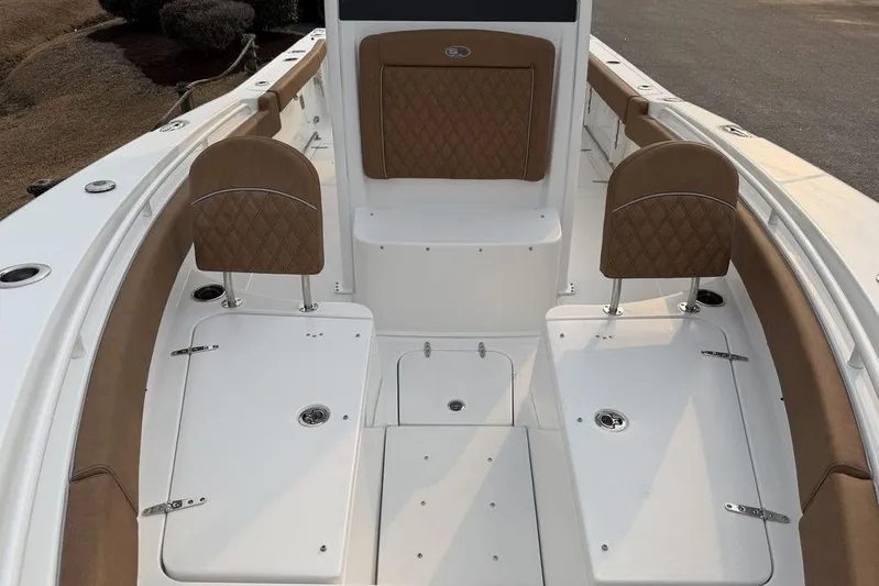  Yacht Photos Pics 2026 Sea Hunt Gamefish 25 boat interior with tan seating and storage compartments.