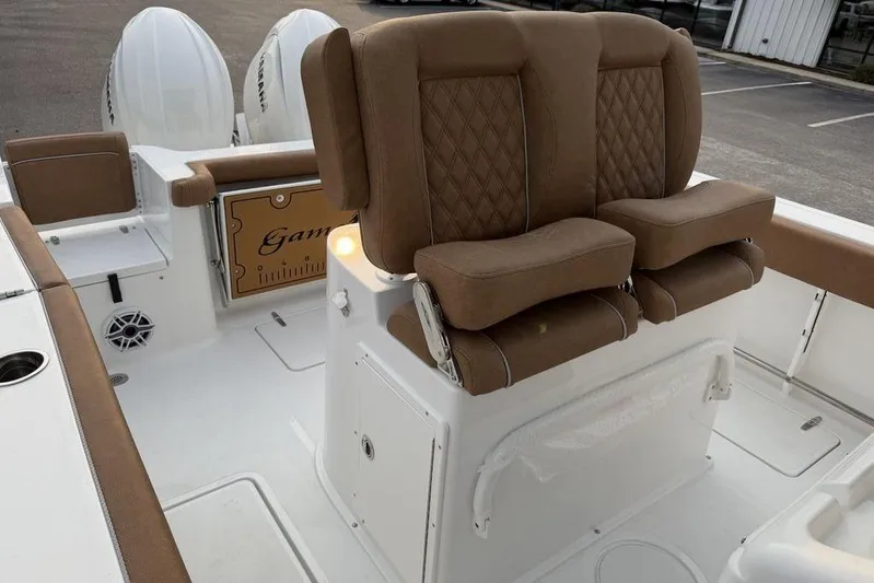  Yacht Photos Pics 2026 Sea Hunt Gamefish 25 boat interior with brown cushioned seating and dual engines.