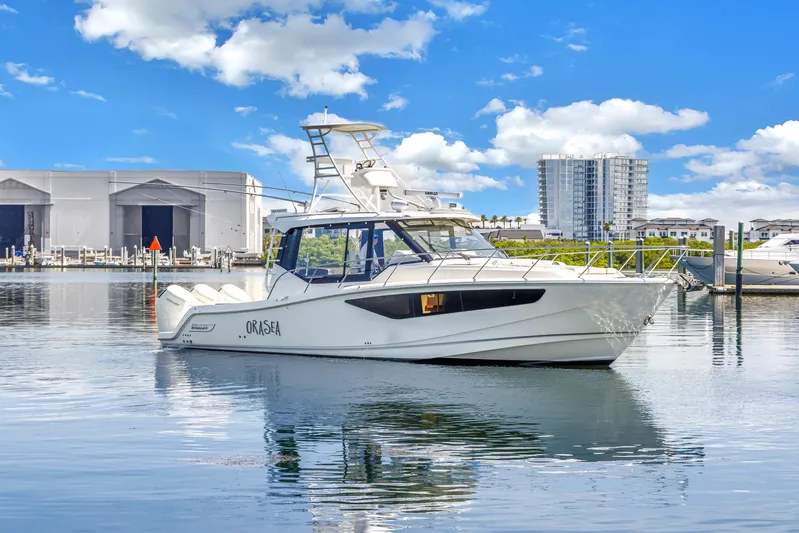  Yacht Photos Pics 2023 Boston Whaler 405 Conquest boat docked in marina, clear sky background.