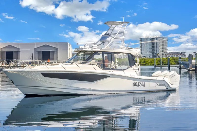  Yacht Photos Pics 2023 Boston Whaler 405 Conquest boat on calm water, clear sky background.