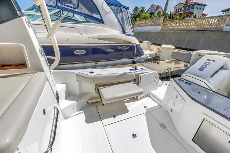  Yacht Photos Pics 2023 Boston Whaler 405 Conquest boat interior with seating and docked view.
