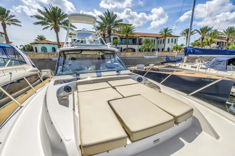  Yacht Photos Pics 2023 Boston Whaler 405 Conquest docked, featuring spacious deck and luxurious seating.