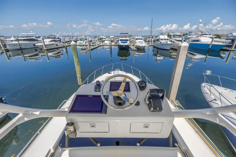  Yacht Photos Pics Helm of 2023 Boston Whaler 405 Conquest overlooking marina with docked boats.