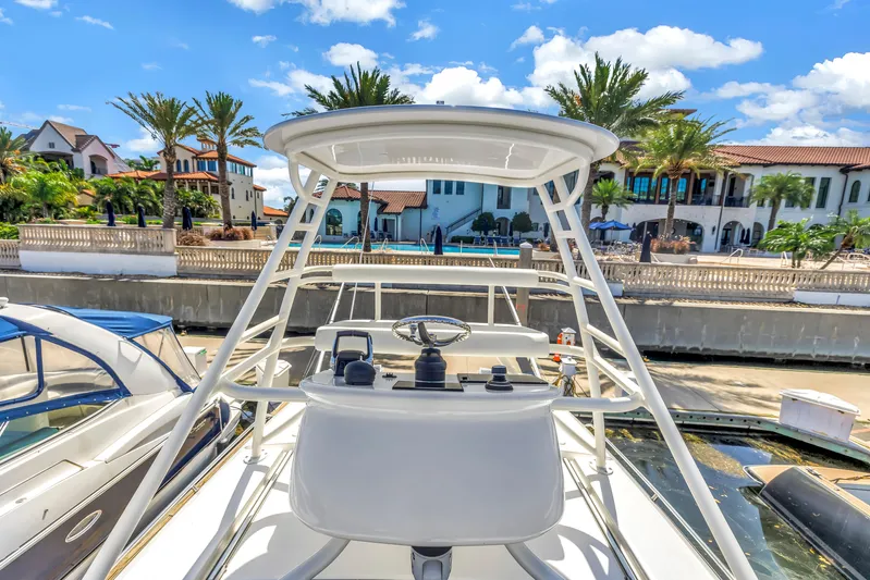  Yacht Photos Pics 2023 Boston Whaler 405 Conquest yacht docked near luxury waterfront homes.