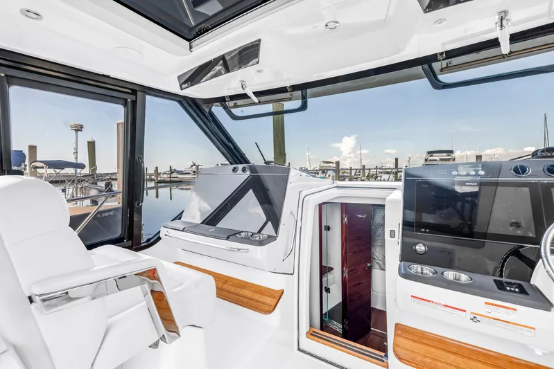  Yacht Photos Pics 2023 Boston Whaler 405 Conquest helm with modern controls and marina view.
