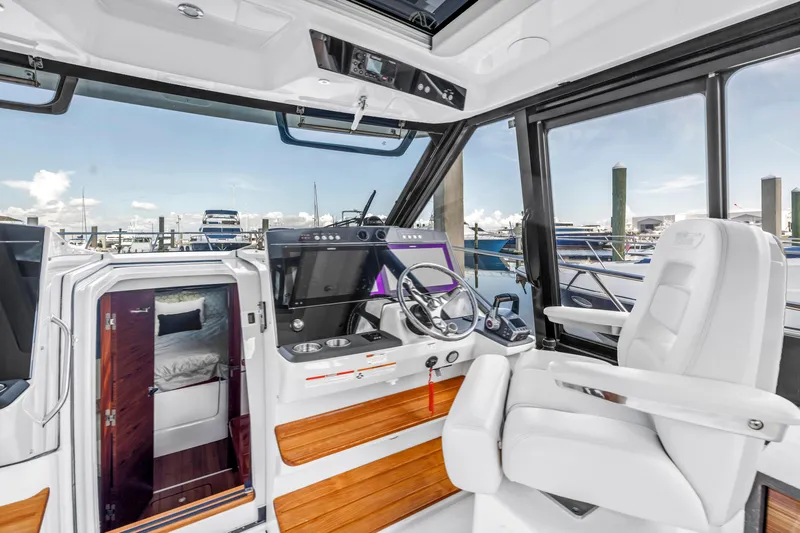  Yacht Photos Pics 2023 Boston Whaler 405 Conquest helm with luxurious seating and modern controls.