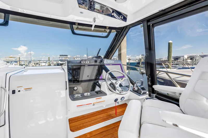  Yacht Photos Pics 2023 Boston Whaler 405 Conquest helm with modern controls and marina view.