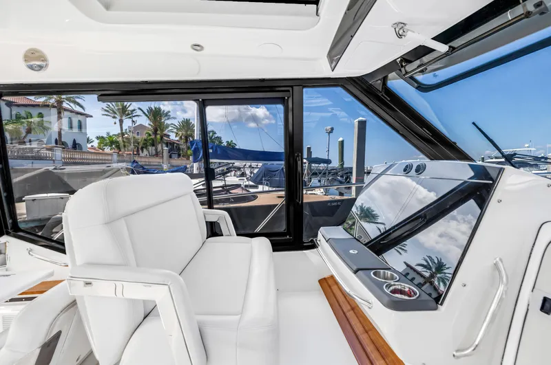  Yacht Photos Pics 2023 Boston Whaler 405 Conquest helm with luxurious seating and marina view.