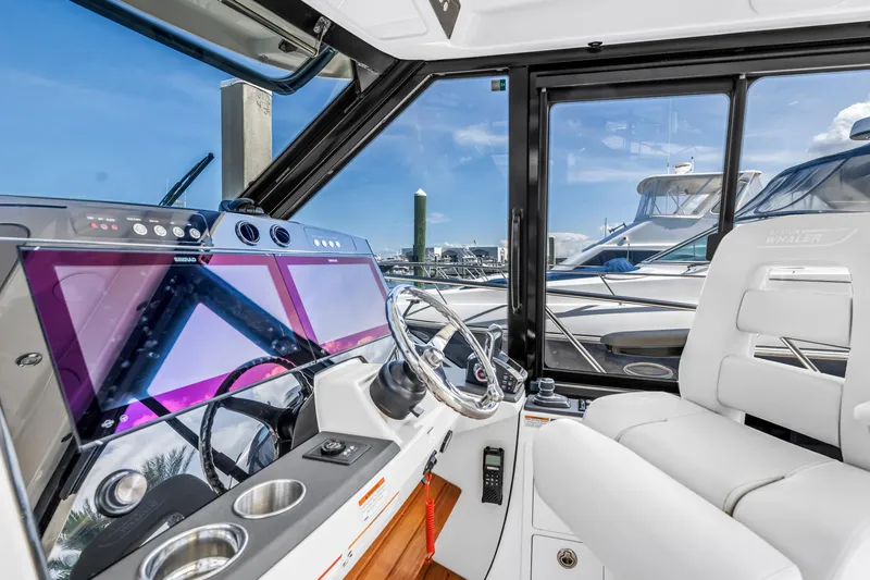  Yacht Photos Pics 2023 Boston Whaler 405 Conquest helm with modern controls and luxurious seating.