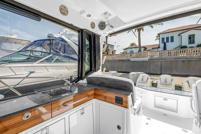  Yacht Photos Pics 2023 Boston Whaler 405 Conquest interior with sleek kitchen and marina view.
