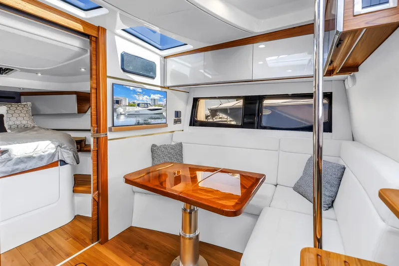  Yacht Photos Pics Luxurious interior of 2023 Boston Whaler 405 Conquest with elegant seating and wooden table.