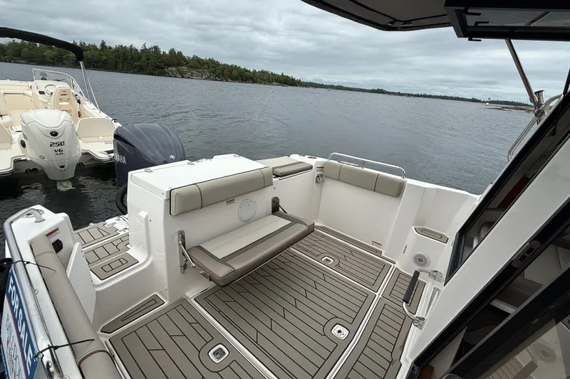  Yacht Photos Pics 2023 Cutwater C-248 Coupe boat interior with seating, docked on a calm lake.