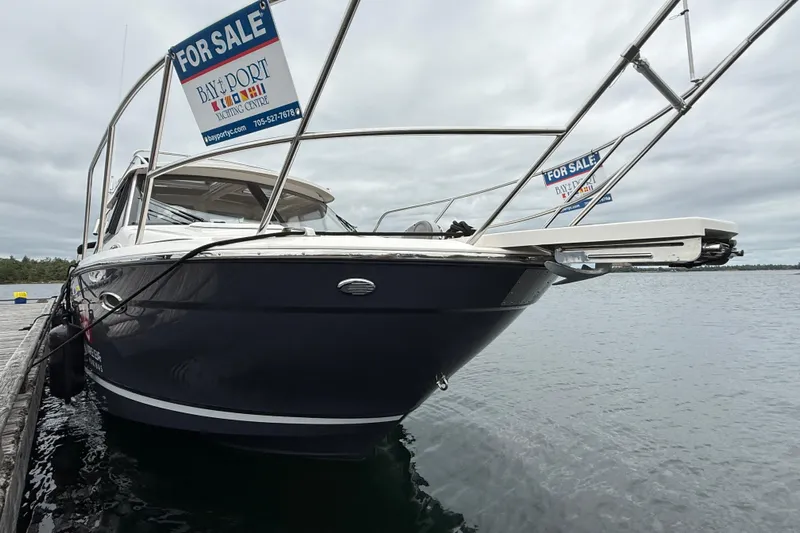  Yacht Photos Pics 2023 Cutwater C-248 Coupe boat for sale, docked on a cloudy day.