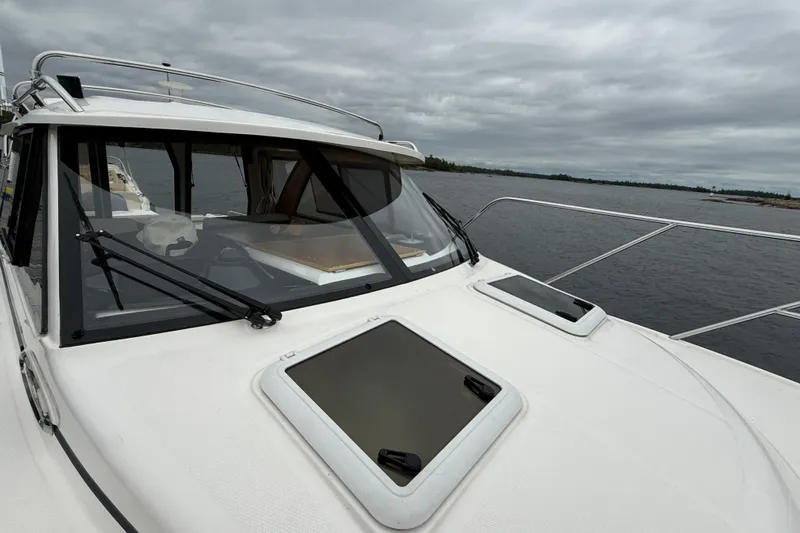  Yacht Photos Pics 2023 Cutwater C-248 Coupe boat on a cloudy day, docked by the water.