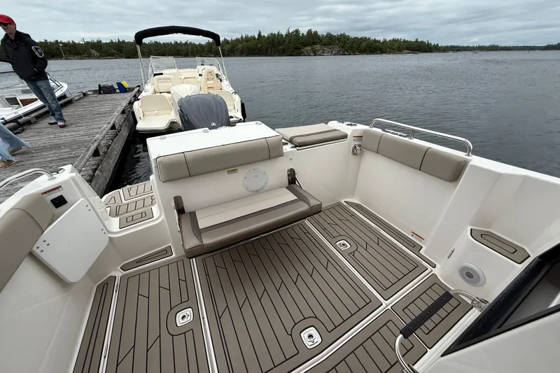  Yacht Photos Pics 2023 Cutwater C-248 Coupe boat interior with seating, docked by a lake.