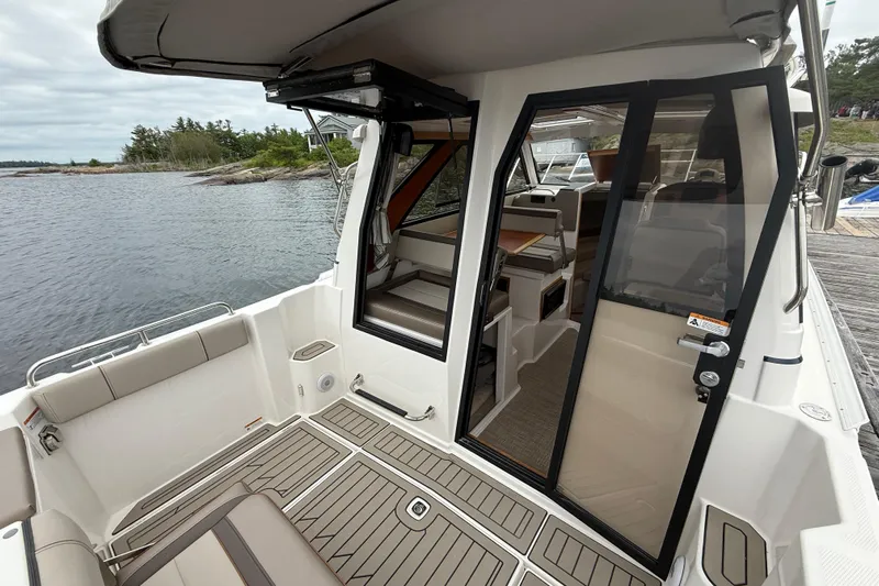  Yacht Photos Pics 2023 Cutwater C-248 Coupe boat interior with open sliding door, dockside view.