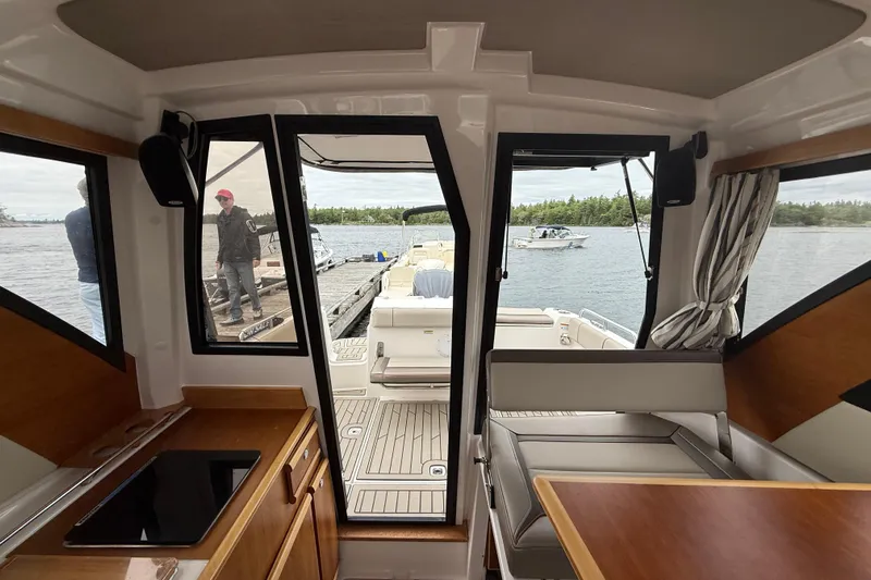  Yacht Photos Pics Interior view of 2023 Cutwater C-248 Coupe boat, featuring seating and water view.
