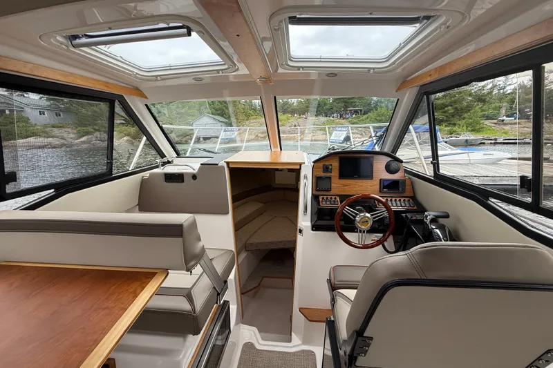  Yacht Photos Pics 2023 Cutwater C-248 Coupe interior with helm, seating, and panoramic windows.