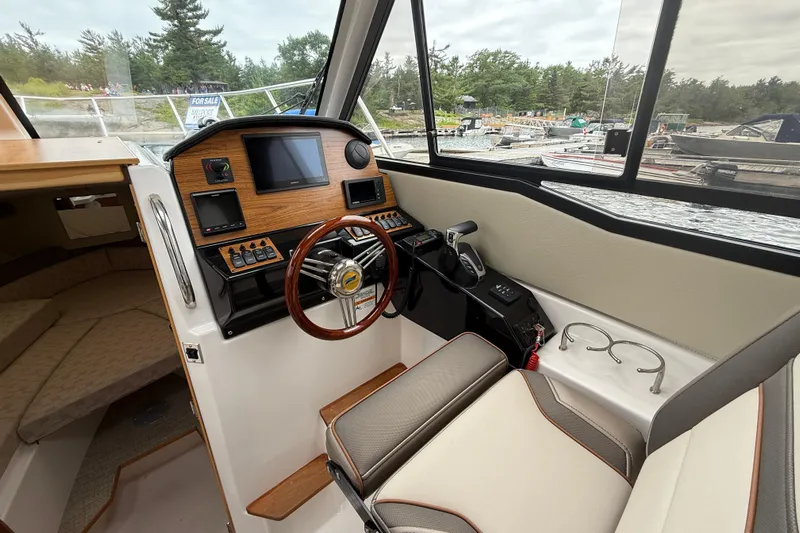  Yacht Photos Pics 2023 Cutwater C-248 Coupe interior with helm, steering wheel, and navigation controls.