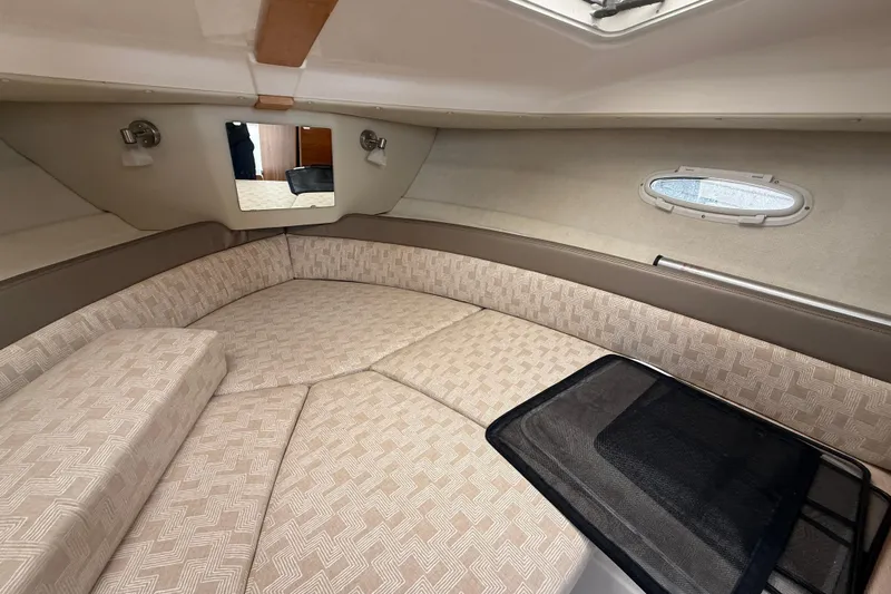  Yacht Photos Pics 2023 Cutwater C-248 Coupe interior cabin with beige upholstery and small window.