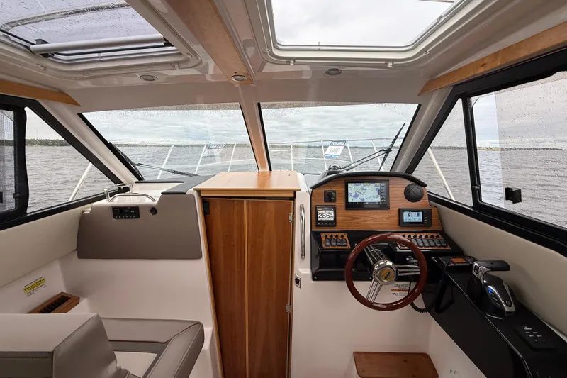  Yacht Photos Pics Interior of 2023 Cutwater C-248 Coupe boat with modern dashboard and steering wheel.