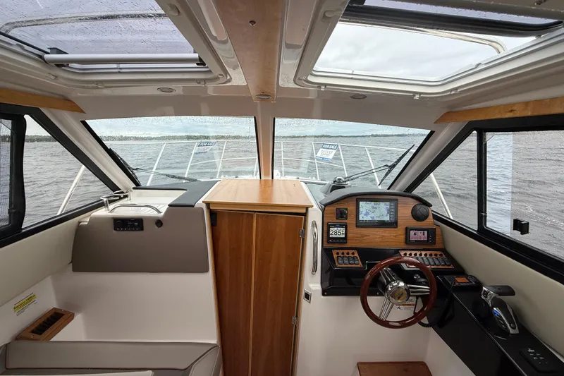  Yacht Photos Pics Interior view of 2023 Cutwater C-248 Coupe boat cockpit with navigation controls.