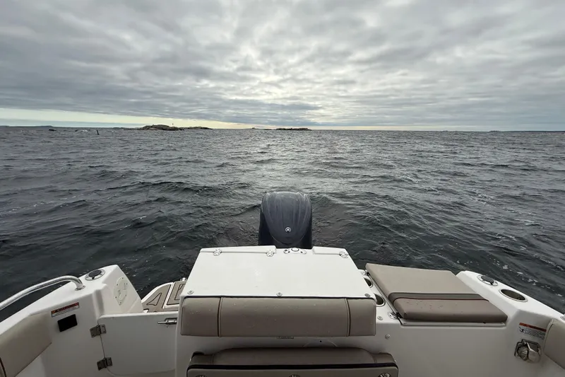  Yacht Photos Pics 2023 Cutwater C-248 Coupe boat on open sea under cloudy sky.