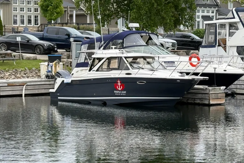  Yacht Photos Pics 2023 Cutwater C-248 Coupe docked at marina, featuring sleek design and Maple Leaf Marinas logo.