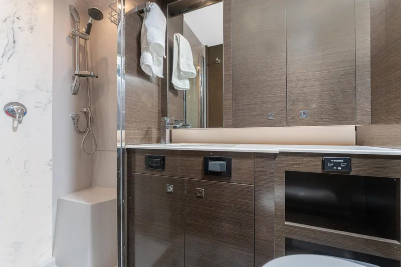 Lil' Darlin' Yacht Photos Pics Luxurious bathroom in 2018 Cruisers Yachts 50 Cantius with modern fixtures and wood cabinetry.